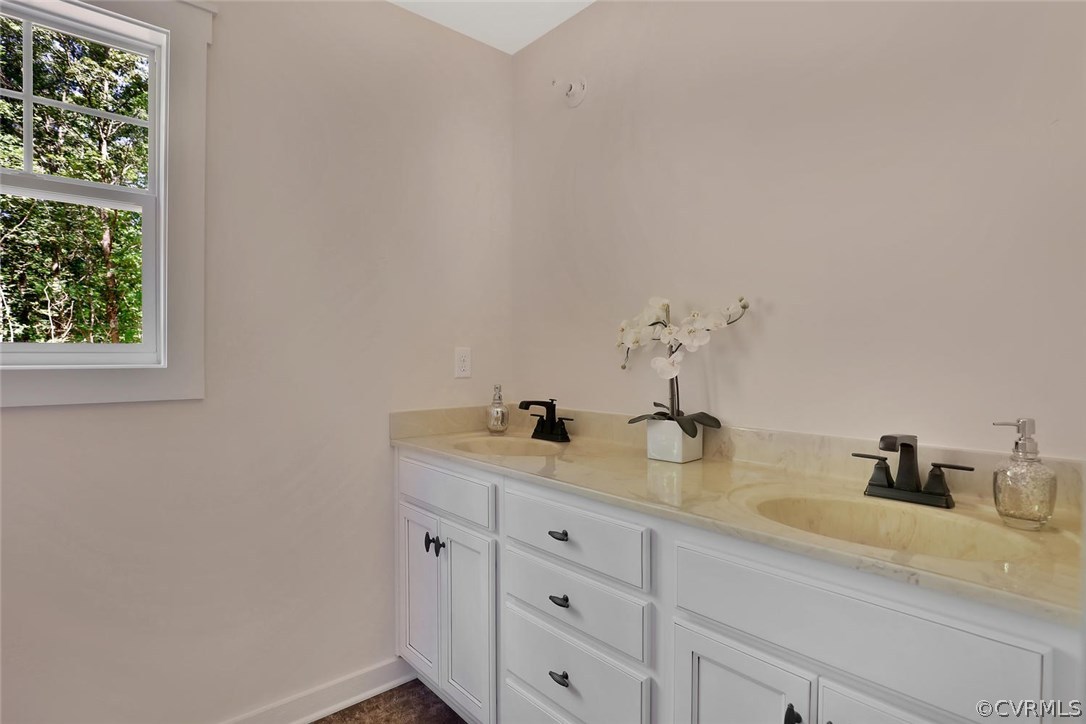 19410 River Road Chesterfield, VA 23838 - Photo 27 of 32 a bathroom with a granite countertop sink and a mirror