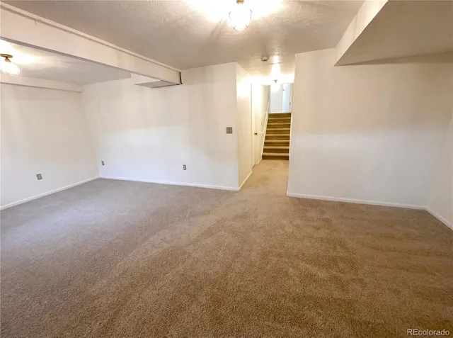 an empty room with windows and entryway