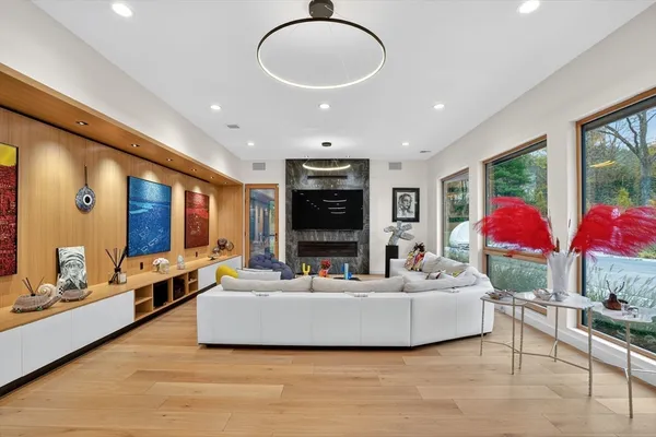a living room with fireplace furniture and a large window