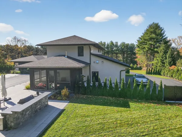 a view of a house with swimming pool and a yard