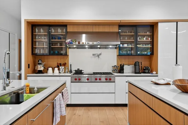 a kitchen with stainless steel appliances a stove and wooden cabinets