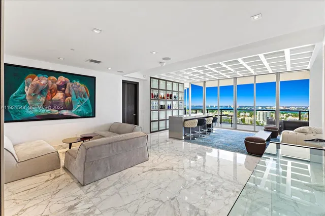 a living room with furniture a rug and a flat screen tv
