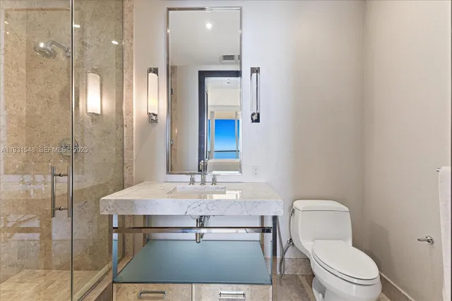 a bathroom with a toilet a sink and shower