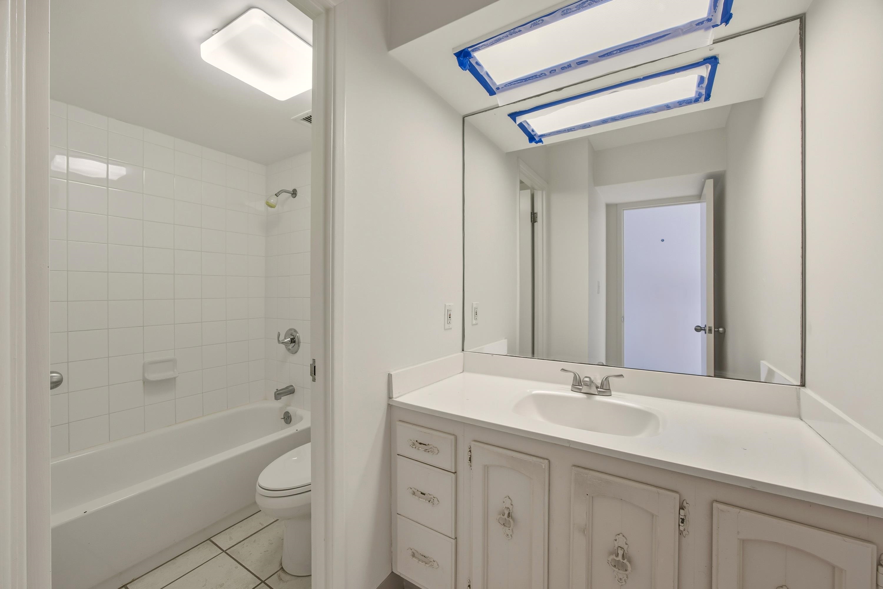 475 Front Street, Unit 334 Lahaina, HI 96761 - Photo 10 of 36 a bathroom with a sink a toilet a mirror a vanity and bathtub