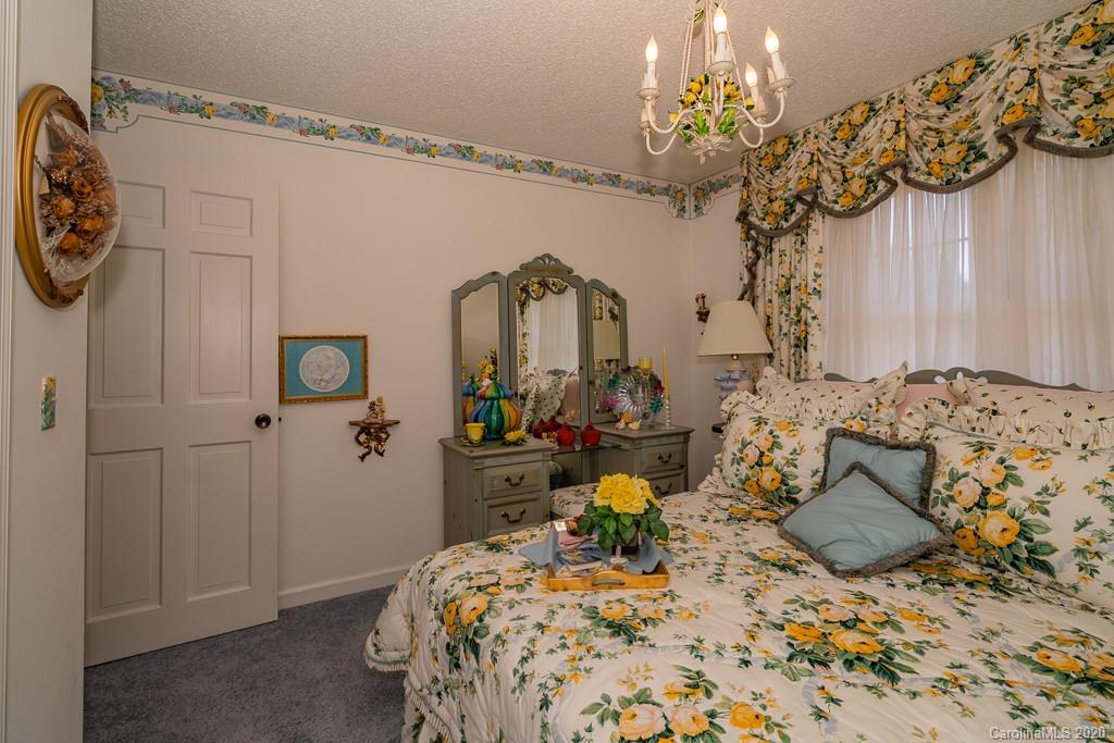 2901 (3 Acres) Screaming Eagle Road Lugoff, SC 29078 - Photo 13 of 48 a bed room with a bed mirror and a chandelier