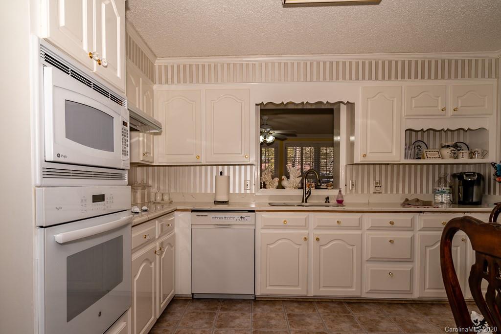 2901 (3 Acres) Screaming Eagle Road Lugoff, SC 29078 - Photo 20 of 48 a kitchen with white cabinets and sink