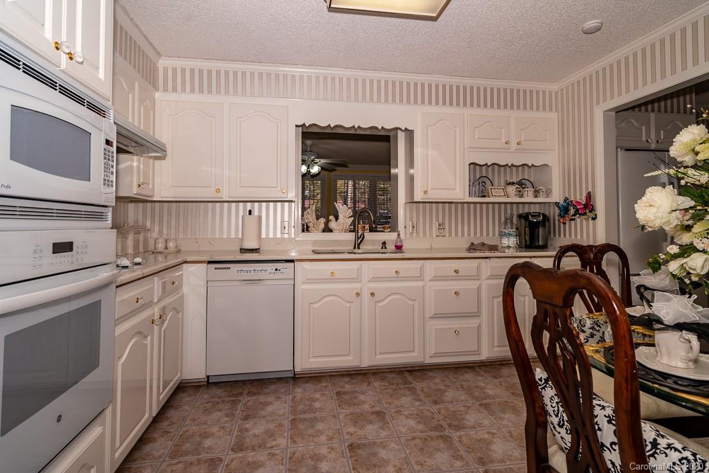 2901 (3 Acres) Screaming Eagle Road Lugoff, SC 29078 - Photo 21 of 48 a kitchen with white cabinets and sink