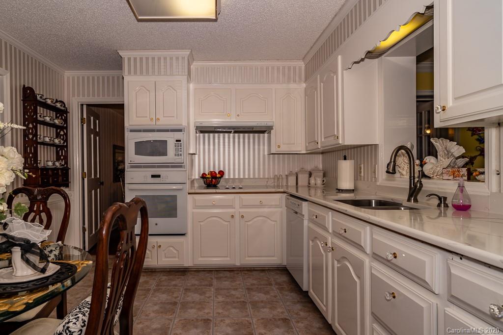 2901 (3 Acres) Screaming Eagle Road Lugoff, SC 29078 - Photo 22 of 48 a kitchen with stainless steel appliances granite countertop a sink refrigerator and cabinets