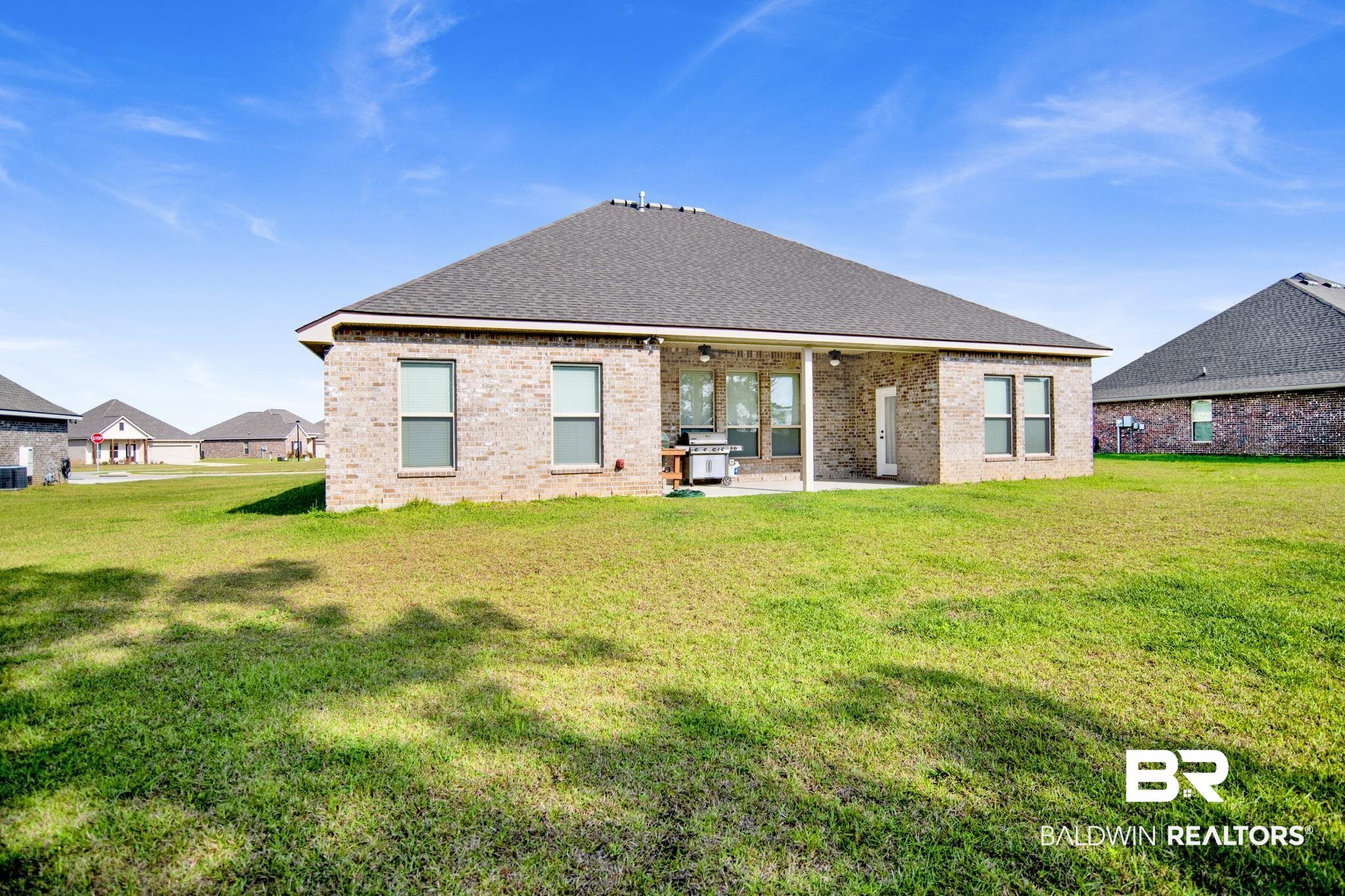 22258 Hibiscus Circle Foley, AL 36535 - Photo 24 of 26 Back of property with a patio area, a lawn, and brick siding