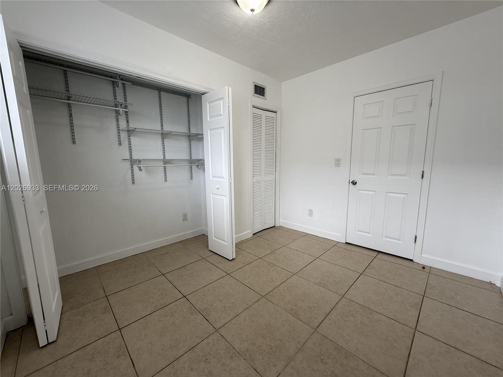 421 Southwest 6th Street, Unit 7 Miami, FL 33130 - Photo 6 of 8 an empty room with cabinet