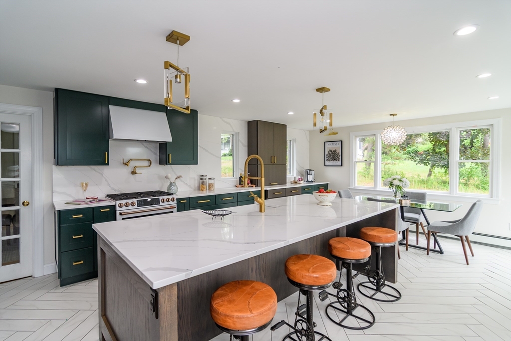 124 Everett Street Natick, MA 01760 - Photo 12 of 36 a large kitchen with a table and chairs