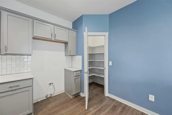 a view of a hardwood & utility room with wooden floor