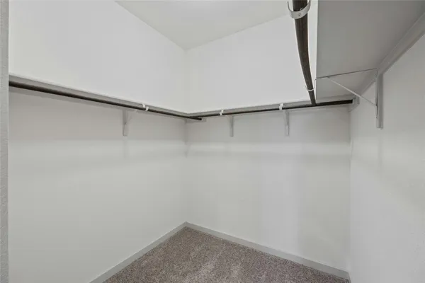 a small space with a wooden floor and a window