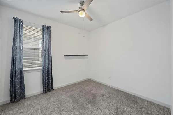 an empty room with closet and windows
