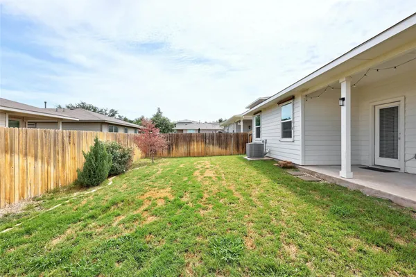 a view of a backyard with plants and a backyard