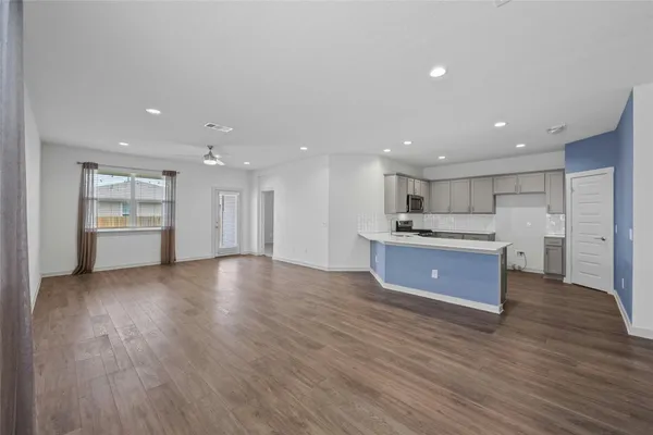 a view of kitchen with wooden floor and window