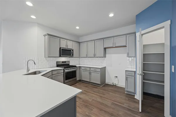 a kitchen with a refrigerator stove and sink