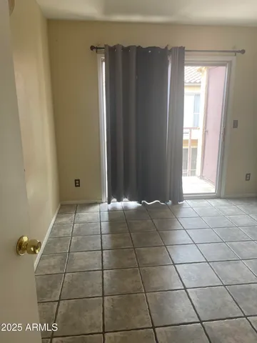 a view of a livingroom with an empty space and a window