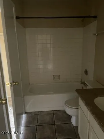 a bathroom with a granite countertop shower toilet and sink