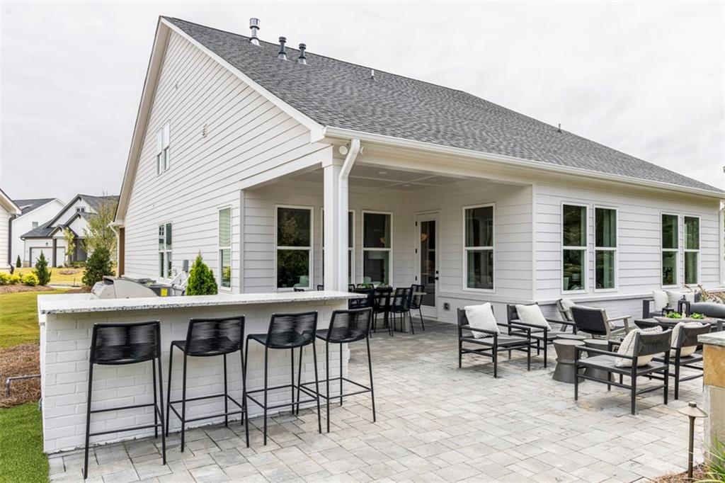 214 Mooney Road Woodstock, GA 30188 - Photo 16 of 17 a view of a dinning table and chairs in the patio