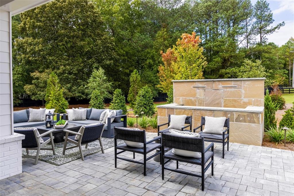 214 Mooney Road Woodstock, GA 30188 - Photo 17 of 17 a view of a patio with table and chairs and potted plants