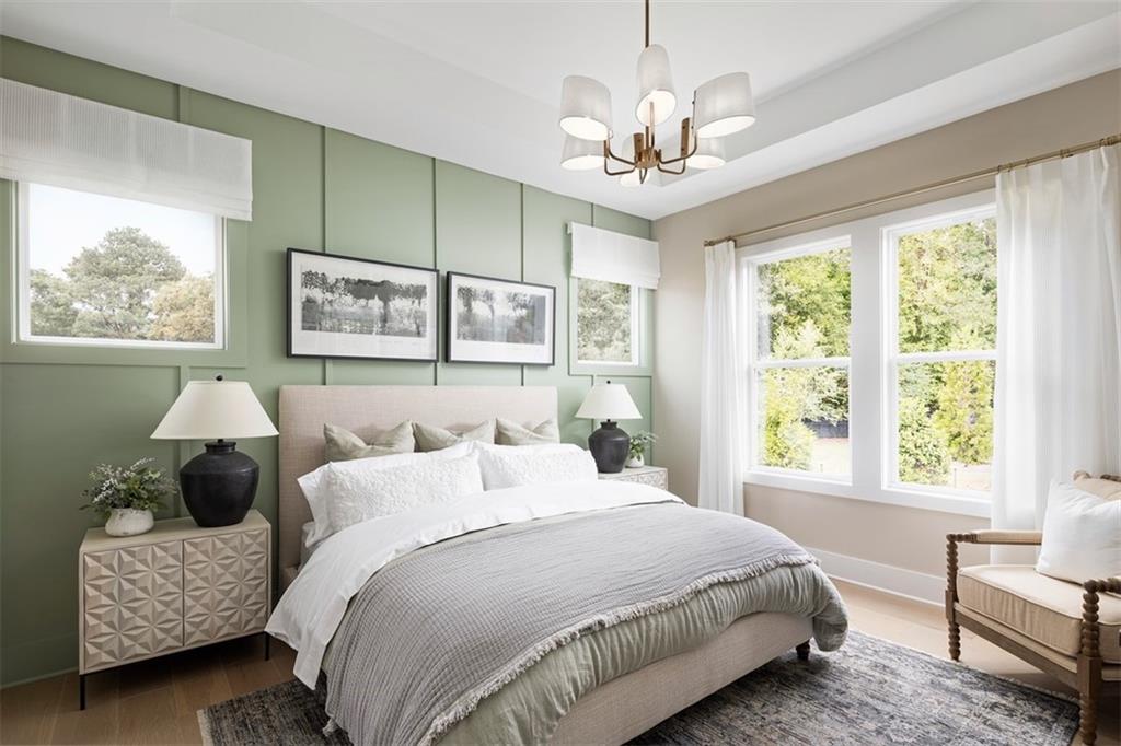 214 Mooney Road Woodstock, GA 30188 - Photo 10 of 17 a spacious bedroom with a bed and a chandelier