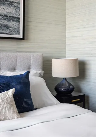 a living room with a couch and a wall painting