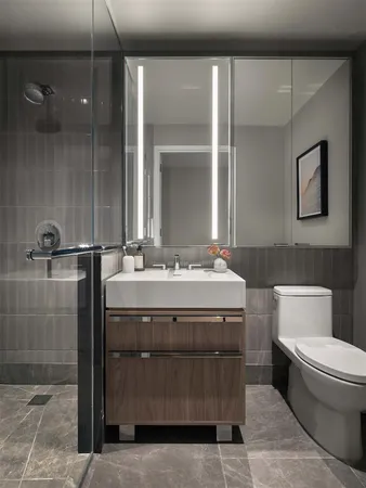 a bathroom with a sink a toilet and shower