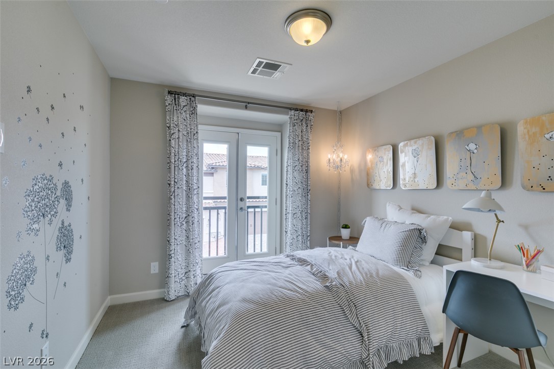653 Pickled Pepper Place Henderson, NV 89011 - Photo 22 of 35 French doors open to a balcony, offering neighborhood views and welcoming fresh air into this comfortable bedroom.