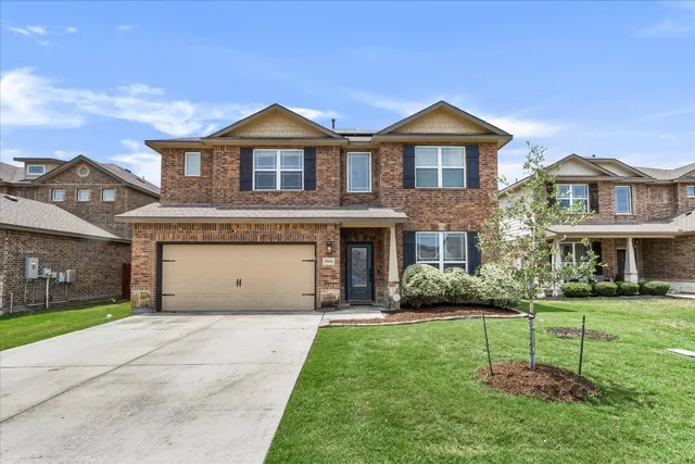 a front view of a house with a garden and plants