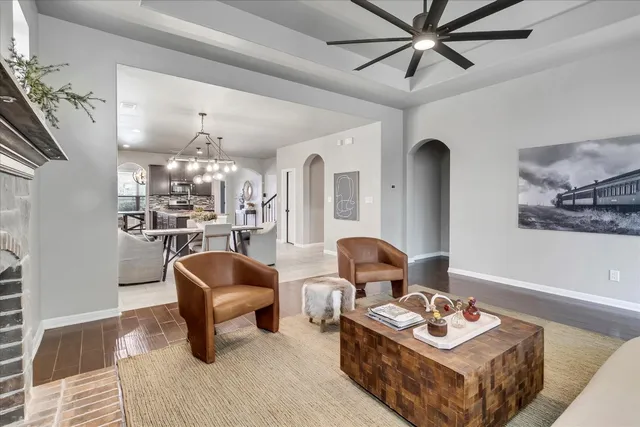 a living room with furniture and a chandelier
