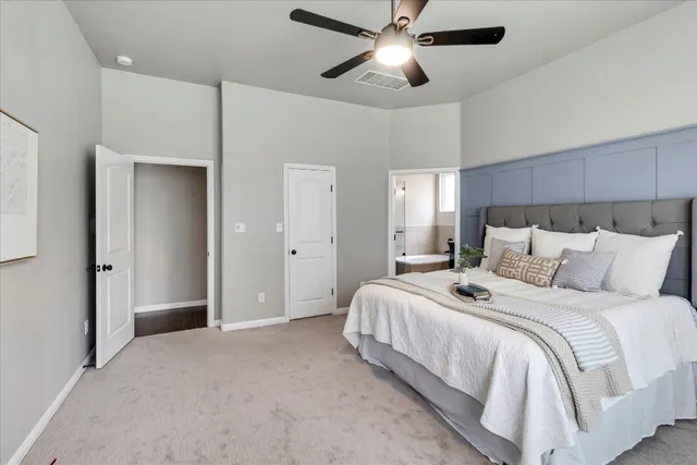 a bedroom with bed and a chandelier