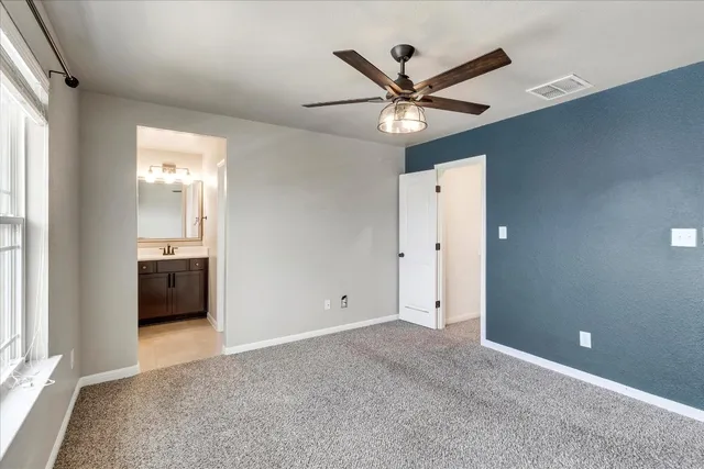 a view of a livingroom with a ceiling fan and window