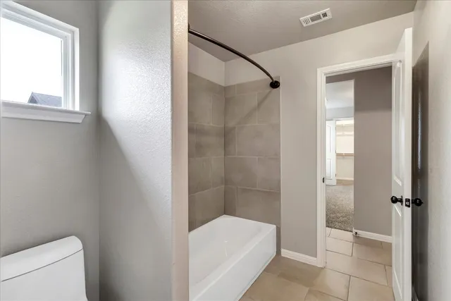 a bathroom with a tub and a shower