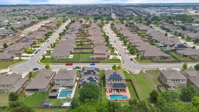 an aerial view of residential houses with outdoor space