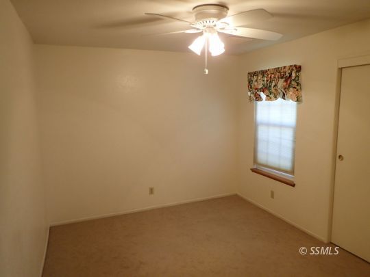 607 Plumblossom Court Ridgecrest, CA 93555 - Photo 10 of 28 an empty room with windows and fan