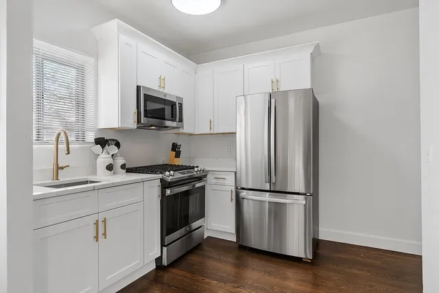 a kitchen with wooden cabinets and stainless steel appliances