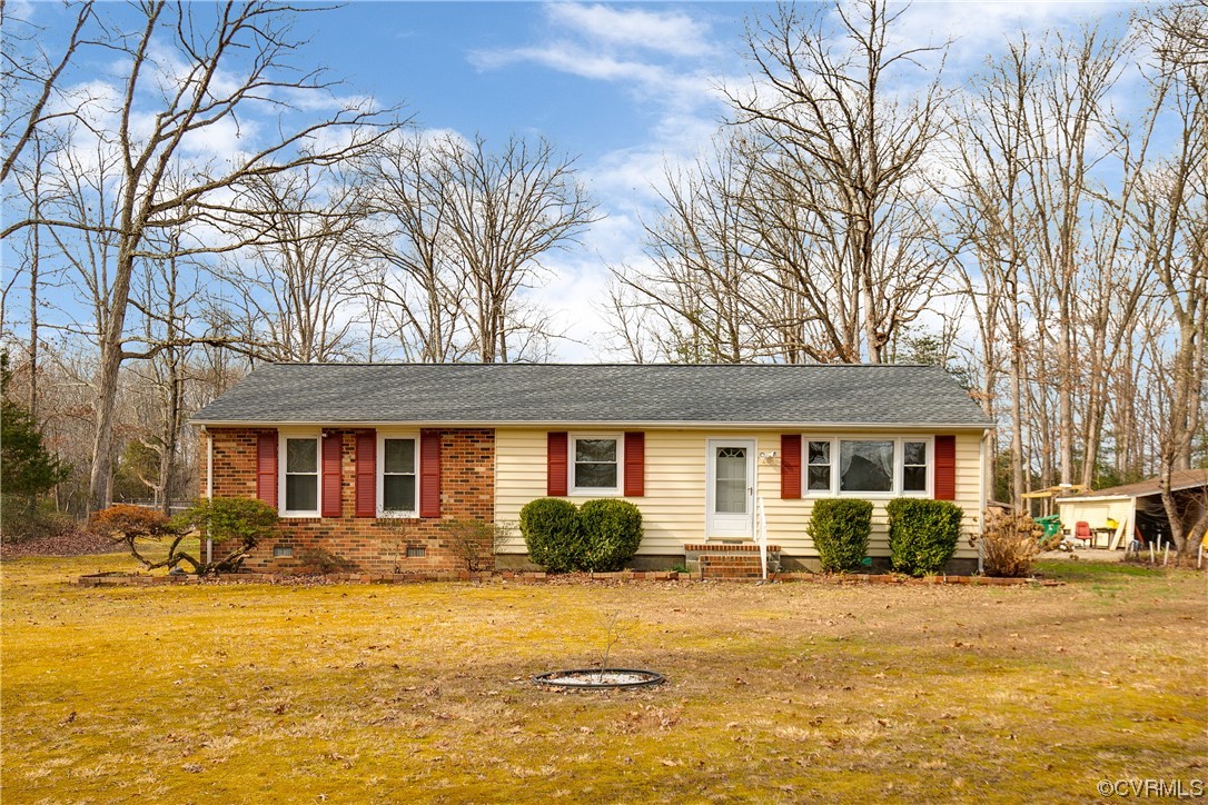 8675 Beatties Mill Road Mechanicsville, VA 23111 - Photo 1 of 25 a front view of a house with a yard and trees
