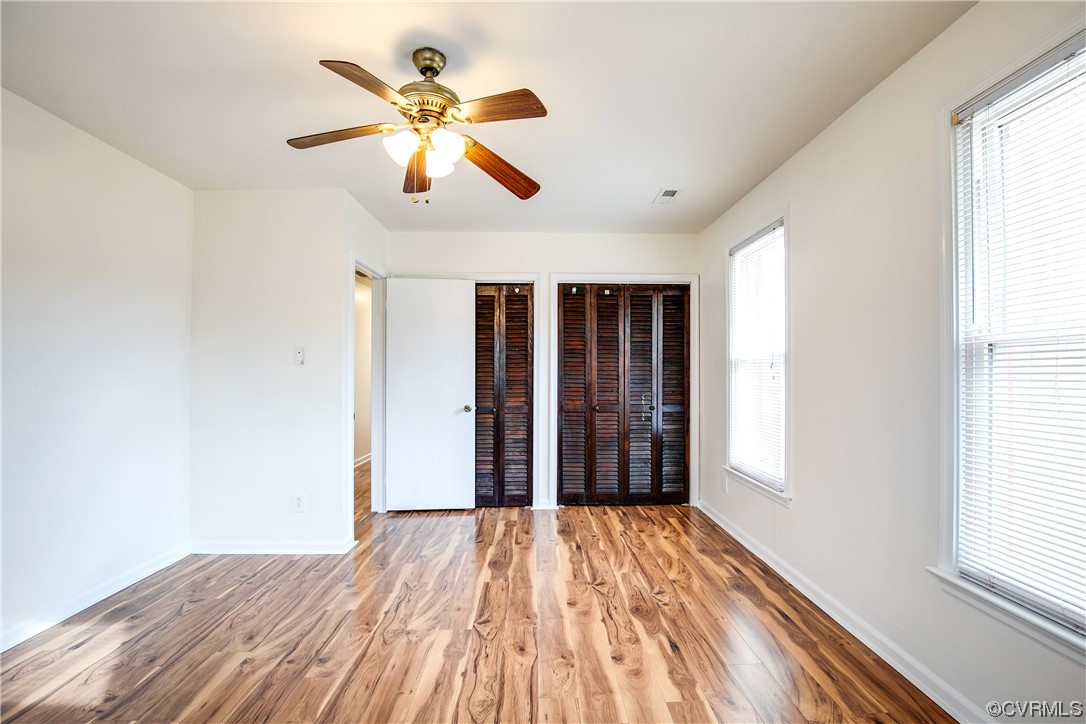 8675 Beatties Mill Road Mechanicsville, VA 23111 - Photo 16 of 25 a view of empty room with wooden floor and fan