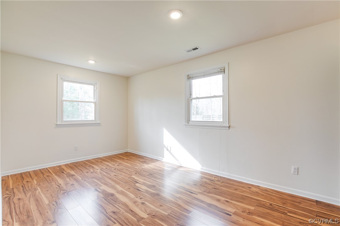 8675 Beatties Mill Road Mechanicsville, VA 23111 - Photo 19 of 25 a view of empty room with wooden floor and fan