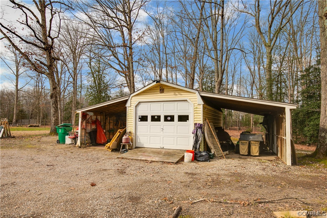 8675 Beatties Mill Road Mechanicsville, VA 23111 - Photo 24 of 25 a view of a wooden house with large trees and playing area