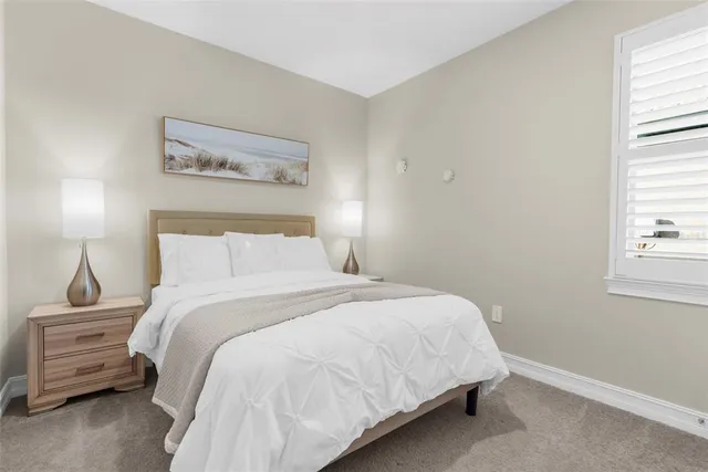 a bedroom with a bed and a night stand