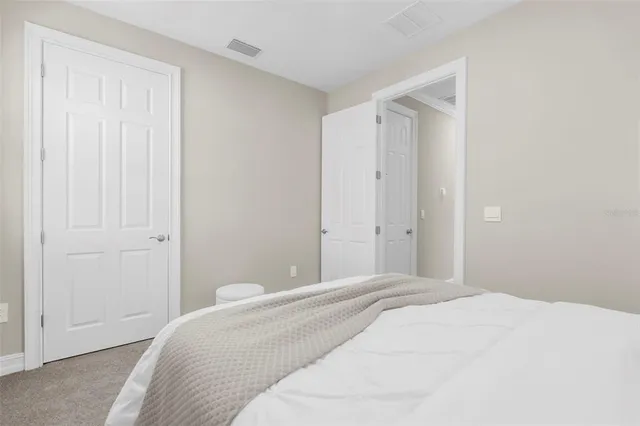 a bedroom with a bed and a shower