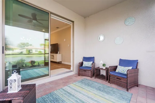 a living room with furniture and a floor to ceiling window