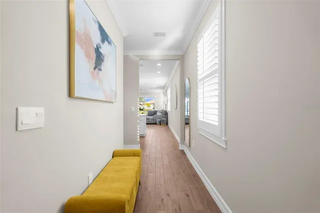 a view of a hallway with wooden floor and staircase