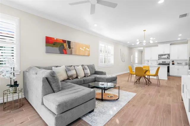 a living room with furniture and kitchen view