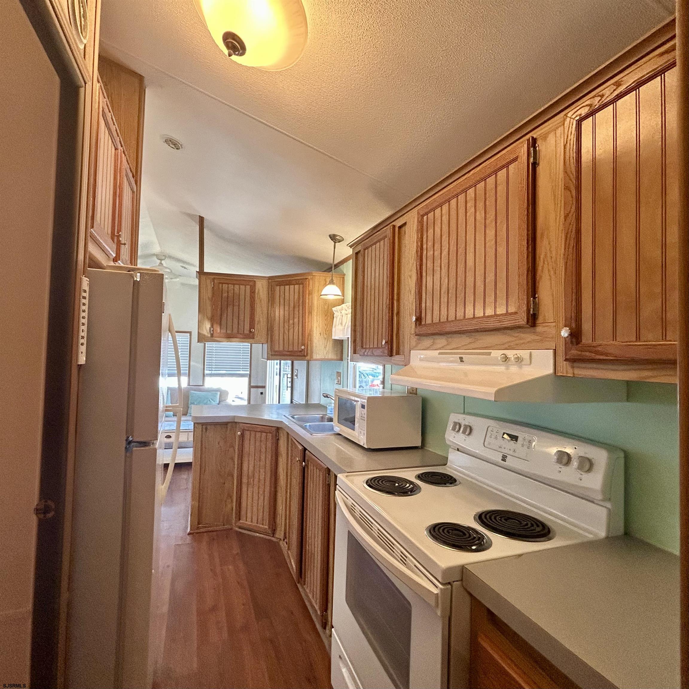 104 South 5th Avenue Rio Grande, NJ 08242 - Photo 11 of 20 a kitchen with a stove a sink and a refrigerator