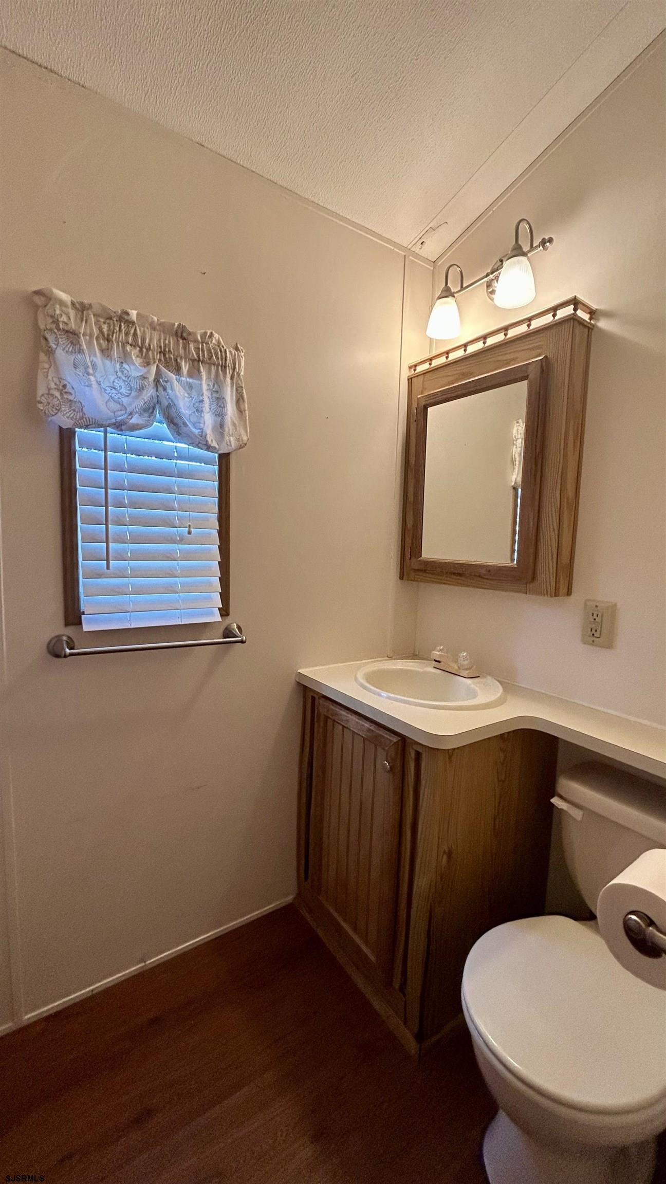 104 South 5th Avenue Rio Grande, NJ 08242 - Photo 12 of 20 a bathroom with a toilet sink and mirror