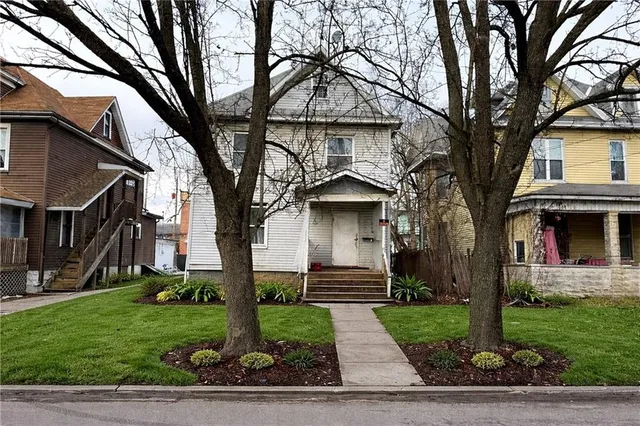 a front view of a house with garden