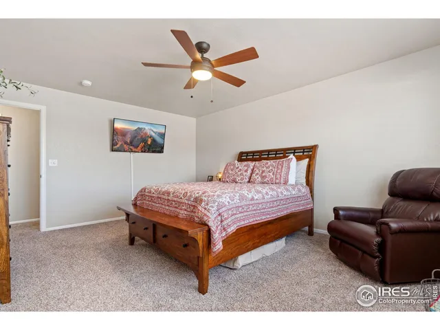 a bedroom with a bed couch and window